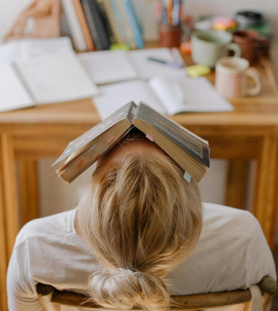 Woman looking unsure while holding a book, symbolizing didn't like the book club pick