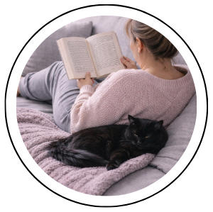 about bcr founder with black cat reading book on couch